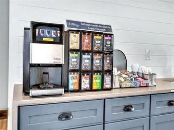 A counter with a coffee machine and some boxes of coffee on it